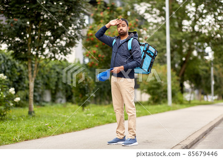 tired indian delivery man with bag in city tired indian delivery man with bag in city 85679446