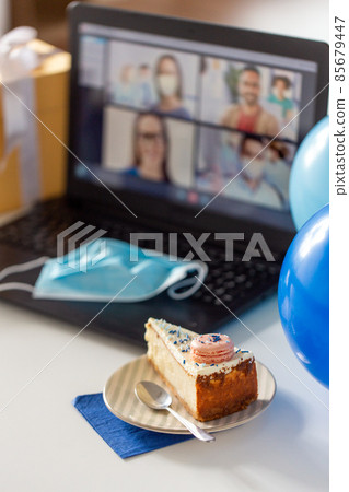 birthday cake and laptop with video call on screen birthday cake and laptop with video call on screen 85679447