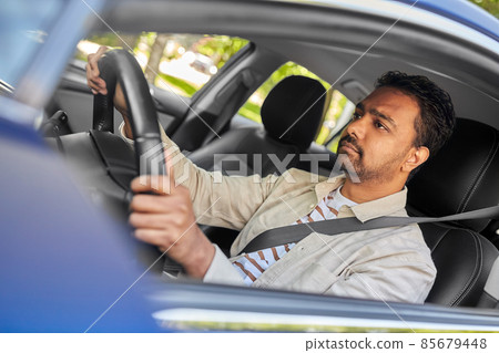 indian man or driver driving car indian man or driver driving car 85679448
