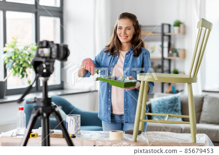 woman or blogger showing old chair renovation woman or blogger showing old chair renovation 85679453