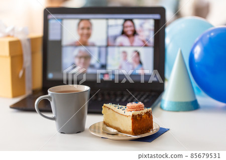birthday cake and laptop with video call on screen birthday cake and laptop with video call on screen 85679531
