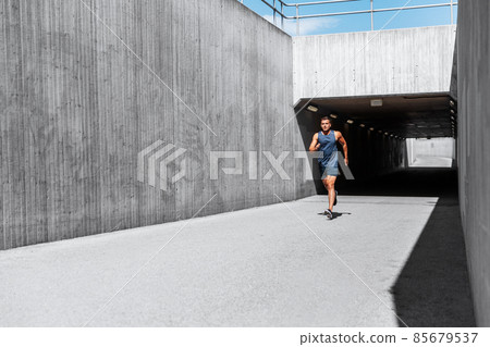 young man running out of tunnel young man running out of tunnel 85679537