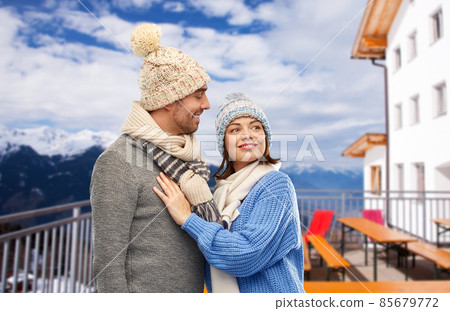 couple over mountains and ski resort in winter couple over mountains and ski resort in winter 85679772