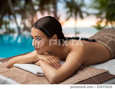 woman having hot stone massage at spa woman having hot stone massage at spa 85679826