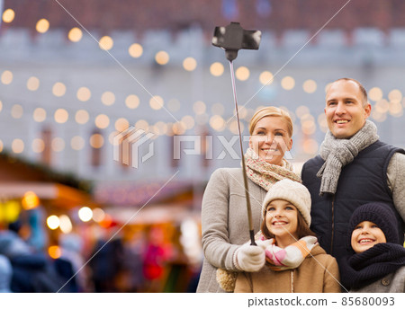 happy family taking selfie at christmas market 85680093