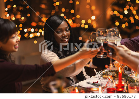 happy friends drinking wine at christmas party 85680178