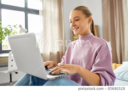 student girl with laptop computer learning at home student girl with laptop computer learning at home 85680328