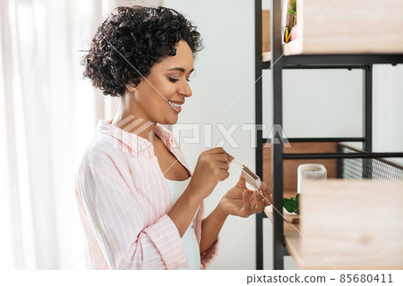 woman with matchsticks lighting candles at home woman with matchsticks lighting candles at home 85680411