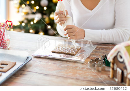 close up of woman making gingerbread house close up of woman making gingerbread house 85680412