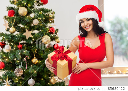 beautiful woman in red dress with christmas gift beautiful woman in red dress with christmas gift 85680422