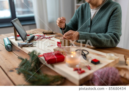 woman making advent calendar on christmas at home woman making advent calendar on christmas at home 85680434