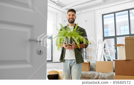 happy man with fern flower and moving to new home happy man with fern flower and moving to new home 85680572
