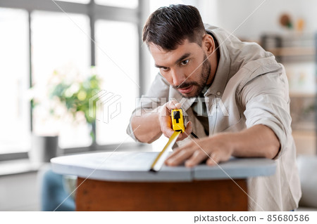 man with ruler measuring table for renovation man with ruler measuring table for renovation 85680586