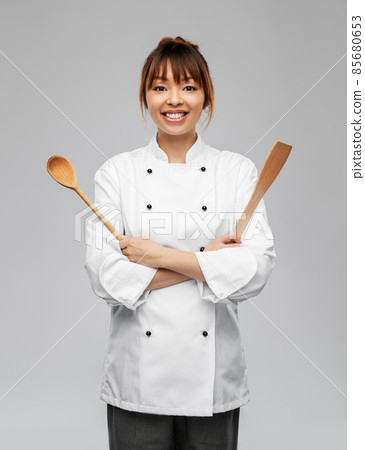 happy smiling female chef with wooden spoon 85680653