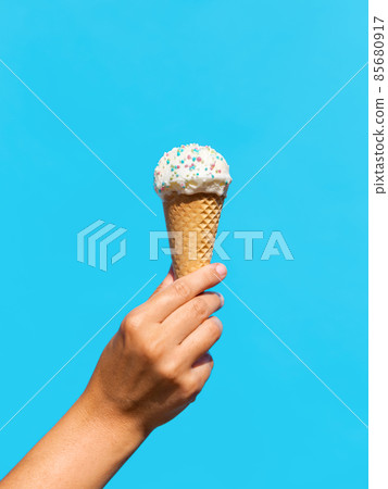 close up of hand holding waffle ice cream cone close up of hand holding waffle ice cream cone 85680917