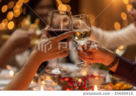 close up of hands toasting wine at christmas party close up of hands toasting wine at christmas party 85680918
