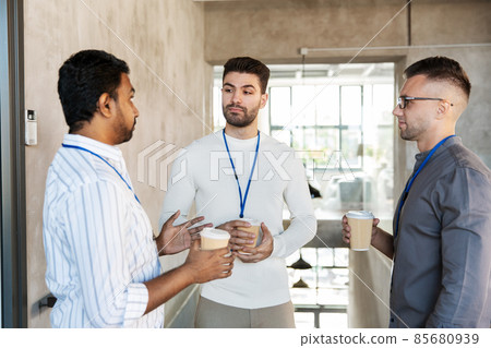 businessmen drinking takeaway coffee at office businessmen drinking takeaway coffee at office 85680939