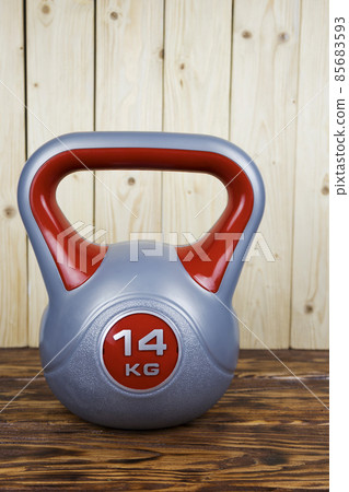 a sports kettlebell on a wooden background. Healthy lifestyle. 85683593