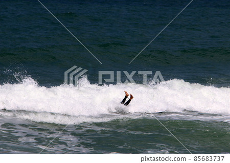 Surfing big waves in the Mediterranean Sea off the northern coast of Israel 85683737