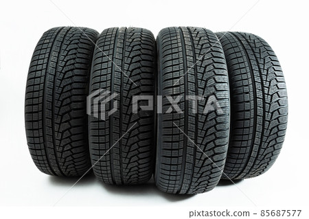 Winter tires rolling forward isolated on white background. Winter tires rolling forward isolated on white background. 85687577