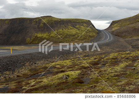 Icelandic road through lava fields and green moss 85688806