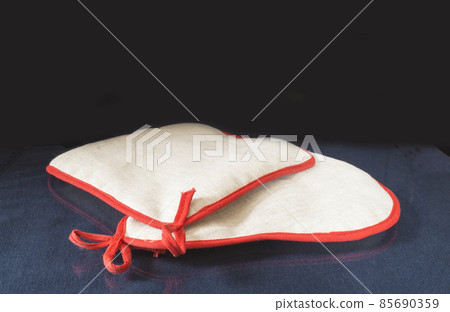 Kitchen pot holder rests upon glass table with reflection Kitchen pot holder rests upon glass table with reflection 85690359