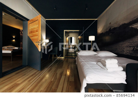 Hotel room. Wood finish. Beautiful interior. White bed Hotel room. Wood finish. Beautiful interior. White bed 85694134