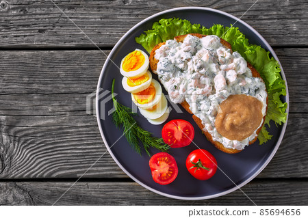 danish smorrebrod with shrimps, mayo, roe, and egg 85694656