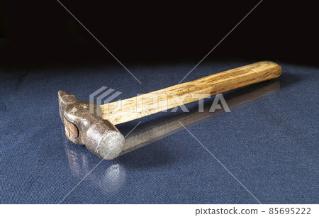 Metallic gavel with wooden handle on glass table Metallic gavel with wooden handle on glass table 85695222