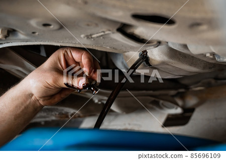 Change of old oil in a car engine. Change of old oil in a car engine. 85696109