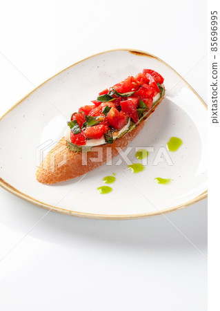 Bruschetta with tomato and basil salad, mozzarella and guacamole for breakfast Bruschetta with tomato and basil salad, mozzarella and guacamole for breakfast 85696995