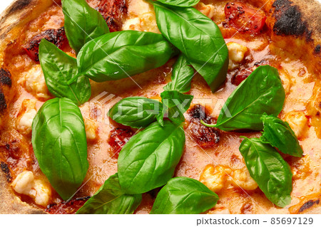 Closeup of Tom yum pizza with shrimps, tomatoes, mozzarella in spicy sauce with basil Closeup of Tom yum pizza with shrimps, tomatoes, mozzarella in spicy sauce with basil 85697129