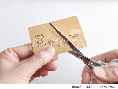 Cut and dispose of expired credit cards with scissors Cut and dispose of expired credit cards with scissors 85698609