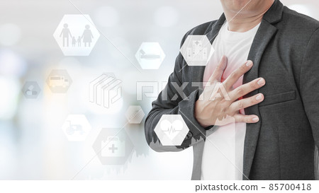 Businessman with heart attack on abstract blur hospital background. Businessman with heart attack on abstract blur hospital background. 85700418