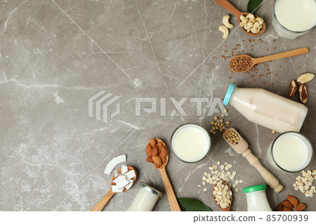 Concept of vegan milk on gray textured background, top view Concept of vegan milk on gray textured background, top view 85700939