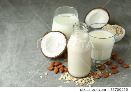 Concept of vegan milk on gray textured background Concept of vegan milk on gray textured background 85700956