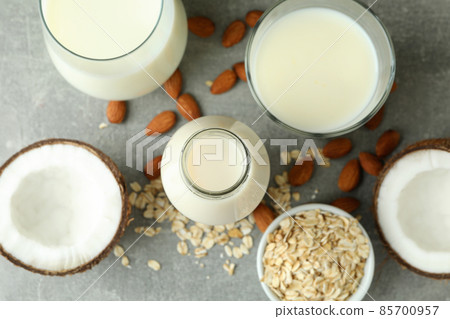 Concept of vegan milk on gray textured background, top view Concept of vegan milk on gray textured background, top view 85700957