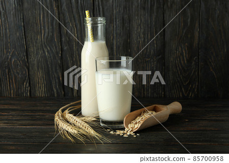 Concept of vegan milk on wooden background Concept of vegan milk on wooden background 85700958