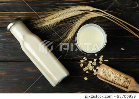 Concept of vegan milk on wooden background Concept of vegan milk on wooden background 85700959