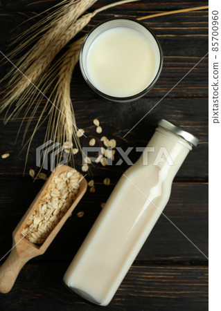 Concept of vegan milk on wooden background Concept of vegan milk on wooden background 85700960