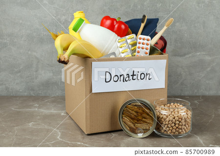 Concept of donate with donation box on gray textured table 85700989