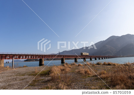 Kyoto Word Railway running on the Yura River Bridge 85701059