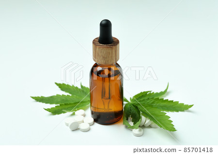 Cannabis leaves, pills and oil on white background Cannabis leaves, pills and oil on white background 85701418