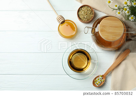 Concept of cooking chamomile tea on white wooden table 85703032