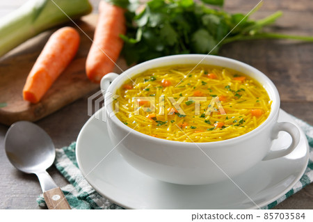 Chicken noodle soup in white bowl Chicken noodle soup in white bowl 85703584