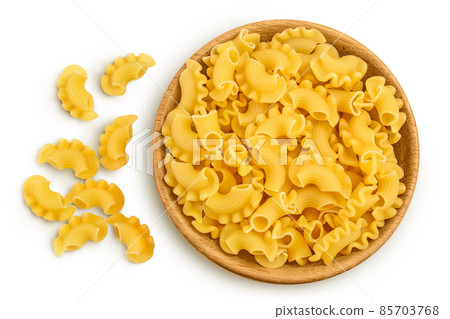 Pasta cornetti creste macaroni in wooden bowl isolated on white background with clipping path and full depth of field. Top view. Flat lay Pasta cornetti creste macaroni in wooden bowl isolated on white background with clipping path and full depth of field. Top view. Flat lay 85703768