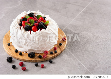 Delicious Pavlova cake with meringue topped and fresh berries Delicious Pavlova cake with meringue topped and fresh berries 85703894
