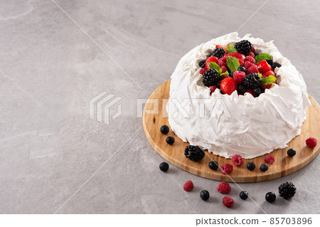 Delicious Pavlova cake with meringue topped and fresh berries Delicious Pavlova cake with meringue topped and fresh berries 85703896