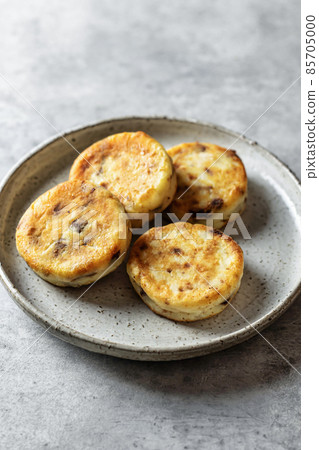 Syrniki or cottage cheese fritters with chocolate on ceramics plate Syrniki or cottage cheese fritters with chocolate on ceramics plate 85705000