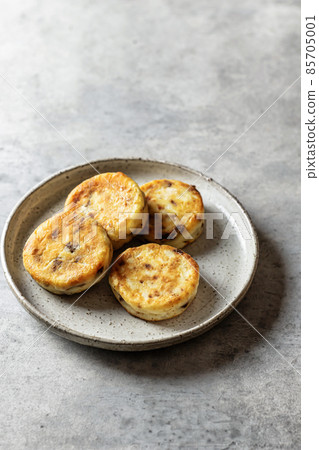 Syrniki or cottage cheese fritters with chocolate on ceramics plate Syrniki or cottage cheese fritters with chocolate on ceramics plate 85705001
